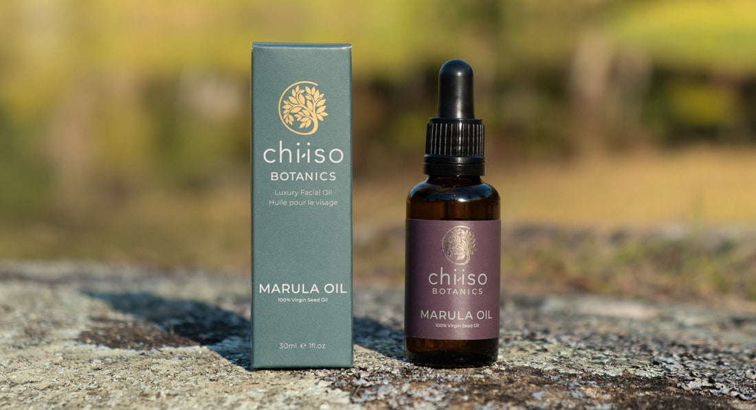 “Chiiso Botanics cold-pressed Marula Oil bottle and packaging outdoors on natural rock surface.